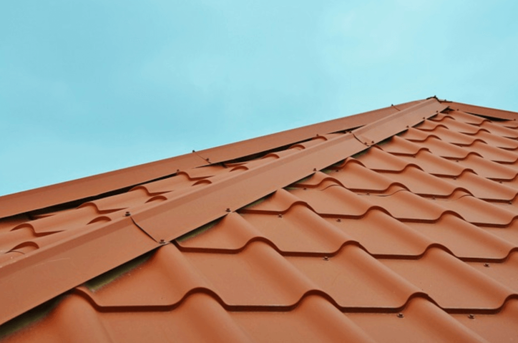 Metal tile residential roof with blue skies in the background