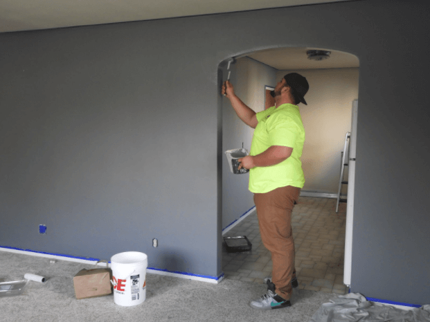 A man painting the inside of his home